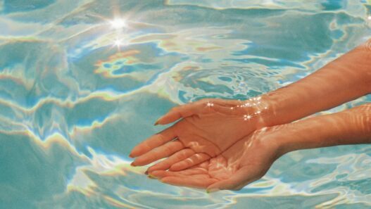 A woman cups her hands underwater