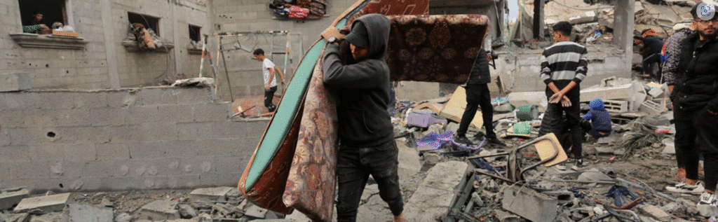 A person walking among rubble in Gaza City.